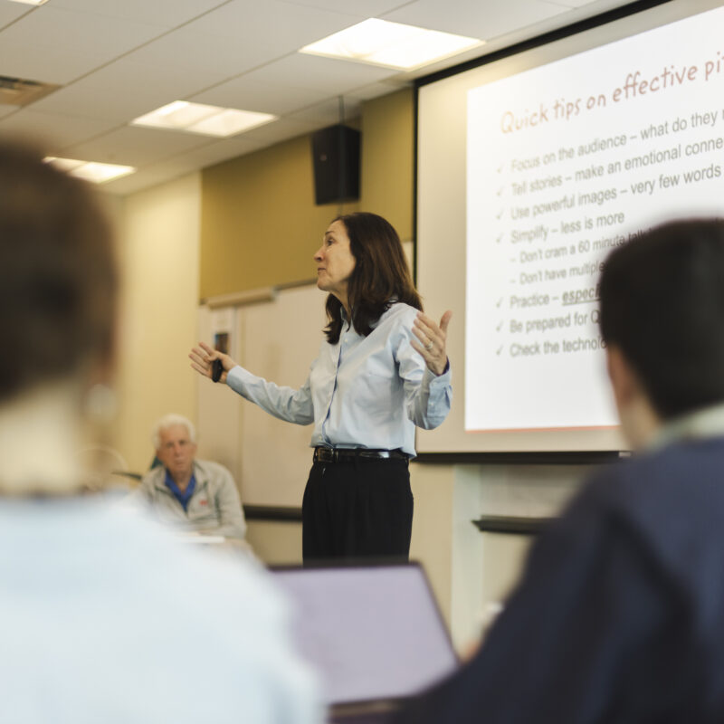 Susan Neal leading students through business workshop.